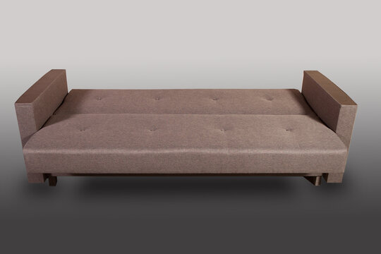 Isolated sofa bed with fabric upholstery on grey gradient background.
