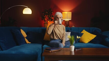 Woman in her 50s taking pill with water at home, healthcare in senior age - Powered by Adobe