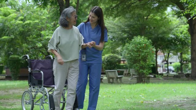 The caregiver is helping an elderly Asian woman rehabilitate her walking and monitor her condition after she underwent knee surgery, using treatment information from her doctor.