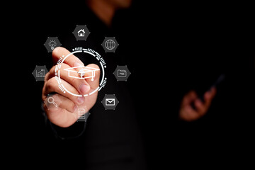 A person interacts with digital icons, showcasing technology and connectivity in a dark setting.