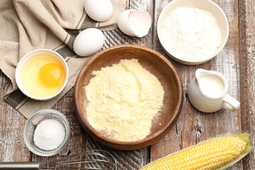 Making cornbread. Different ingredients and metal whisk on wooden table, flat lay