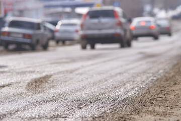 Blurred busy urban street with multiple cars in motion on smooth asphalt road.
