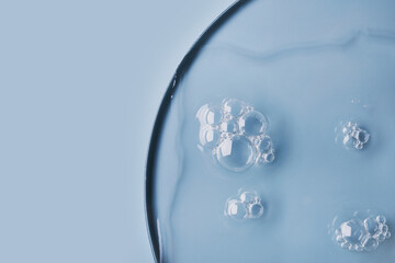 Close-up of bubbles in transparent gel on light blue background