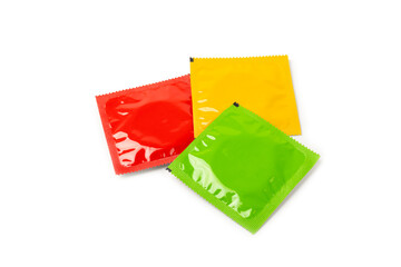 Condoms isolated on white background. Colorful fruit-colored condoms in packaging. Safe sex...