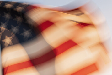 Fototapeta premium blurred american flag waving in the wind on a bright sunny day symbolizing freedom and patriotism