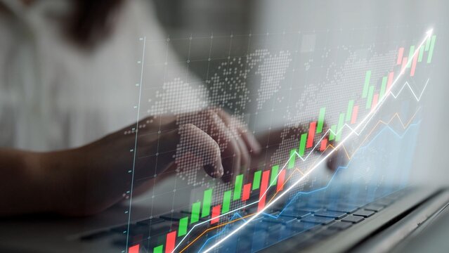 Close-up of hands typing on a laptop with stock market graphs and data visualizations on the screen, showcasing investment trends and financial analysis in a business context. Copula - Powered by Adobe