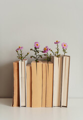 Books decorated with flowers, book aesthetic, warm palette, background with copy space