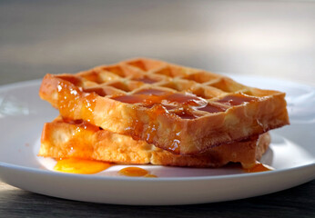 A Stack of Two Freshly Made Belgian Waffles with Amber Honey Jam