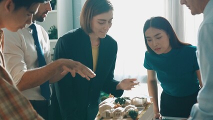 Professional architect engineer sitting while explain house plan to manager. Aerial view of smart...