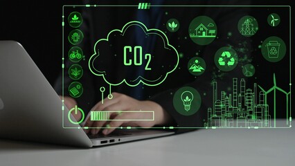 A businessman interacts with a laptop amidst a digital display showcasing green energy icons and CO2 concepts, emphasizing sustainability and innovation in technology. Cipher