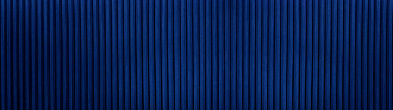 Dark blue or navy Wood slat background use as banner in panorama long view. blue wooden wall texture, seamless pattern. Modern ribbed wooden texture for design and decoration.