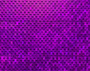 Industrial neon purple or violet concrete wall texture with a gridded pattern of raised rectangles...