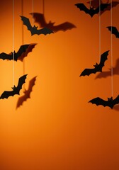 Hanging Paper Bats Casting Shadows on Orange Wall, Minimal Halloween Scene