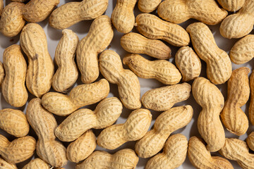 Close up of  peanuts on light surface food pattern