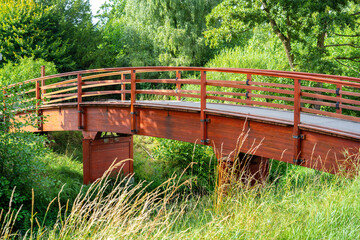 Red wooden Bridge in a Lush Green Landscape of Yverdon les Bains.
