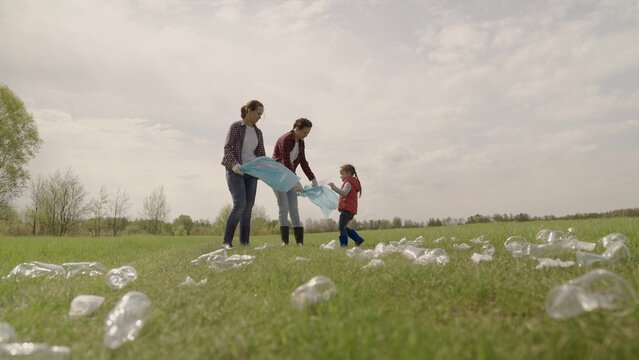 kid collecting trash volunteer teamwork. child group happy family on collects garbage plastic trash waste bottles trash. environmental happy family ecology a teamwork volunteer awareness pollution. - Powered by Adobe