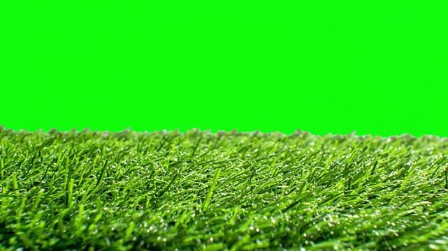 A patch of green grass against a green screen background for easy chroma keying in nature or sports scenes.