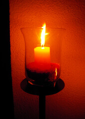 Close-up view of a candle on candlestick in the evening