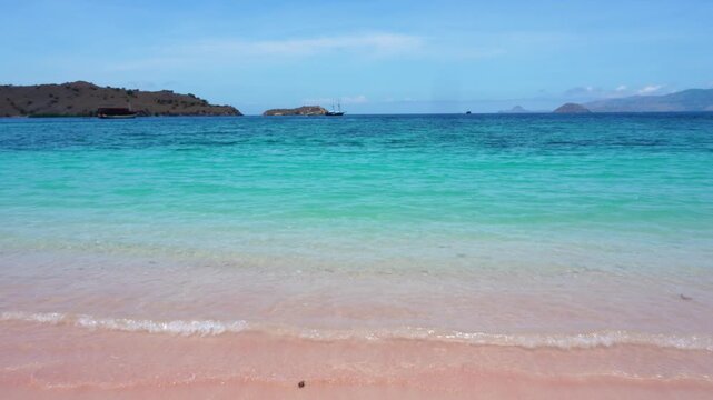 Beautiful Pink beach sea waves in a Comodo or Komodo National park, Indonesia