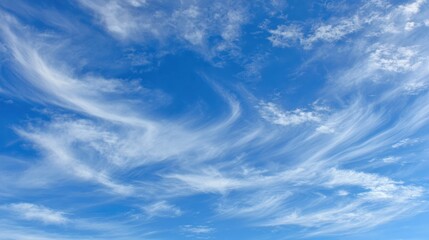 Serene Blue Sky with Wispy Clouds Displaying Natural Beauty
