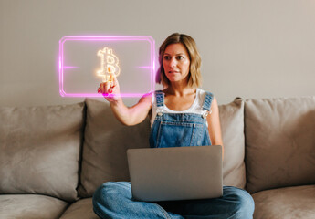 Woman using futuristic interface to interact with glowing Bitcoin symbol