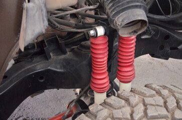 Get inspired by this classic car restoration project with tools, parts, and a vibrant red spray gun for auto enthusiasts and DIY experts