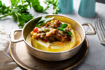 Zucchini stuffed with meat and vegetables, stewed in tomato sauce