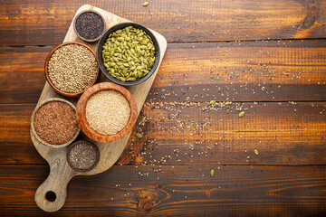 Pumpkin, sesame, flax, hemp, chia seeds in bowls, seeds for good health of mind and body, enriched with minerals and vitamins. Top view, copy space for text