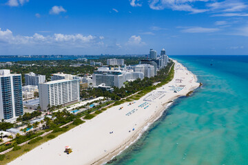 Drone aerial view of Miamis sandy beach. Miami coastline. Wide drone shot of Miami Beach and ocean...