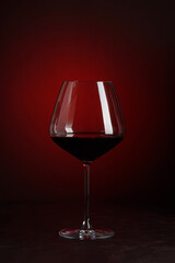 Glass of  Red Wine on Red and Black Gradient Background