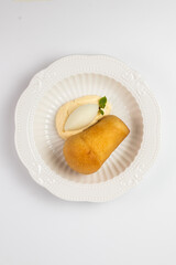 Top view of a rum babka dessert with ice cream on a white background