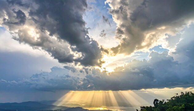 Dramatic sky with sunbeams piercing clouds