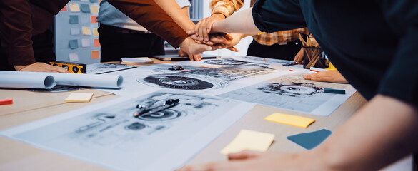 A diverse group of professionals engaged in a collaborative meeting, focusing on project blueprints and ideas, demonstrating teamwork and creativity in a modern office space. SACTR