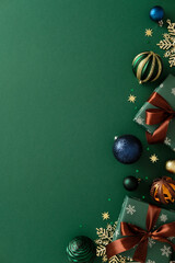 Christmas holiday composition with gifts, baubles, and snowflakes on green background. Flat lay, top view, copy space.