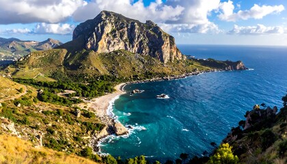 Fototapeta premium A scenic coastal landscape features a rugged mountain meeting a turquoise sea, with a sandy beach nestled in the cove