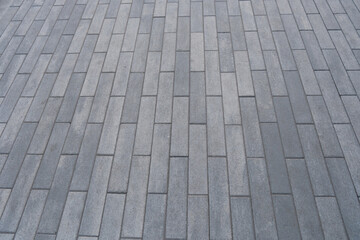 Grey concrete paving pattern forming sidewalk texture