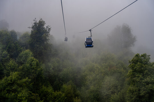 Cable cars in misty forest Qabala Azerbaijan