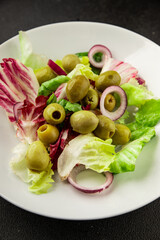 Salad olives, green leaf lettuce, vegetables natural product tasty snack fresh delicious gourmet food background on the table rustic top view copy space keto and paleo diet vegan and vegan food