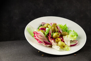 Salad olives, green leaf lettuce, vegetables natural product tasty snack fresh delicious gourmet food background on the table rustic top view copy space keto and paleo diet vegan and vegan food