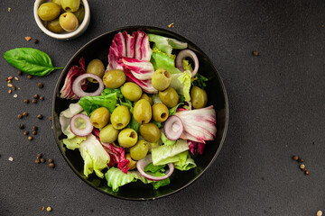 Salad olives, green leaf lettuce, vegetables natural product tasty snack fresh delicious gourmet food background on the table rustic top view copy space keto and paleo diet vegan and vegan food