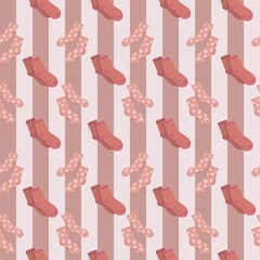 Playful seamless pattern with red and pink cozy socks arranged on striped background, ideal for textile prints, children’s clothing, winter accessories, and festive holiday wrapping paper.