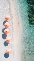 Beautiful beach scene with pink umbrellas lining the shore near clear turquoise water and rocky formations