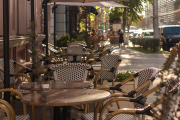 Empty tables at a street cafe in the morning.
