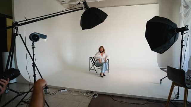 Professional photographer taking pictures of a model in a studio