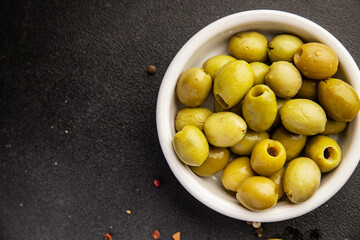 Green olives pickled seedless natural product tasty snack fresh delicious gourmet food background on the table rustic top view copy space