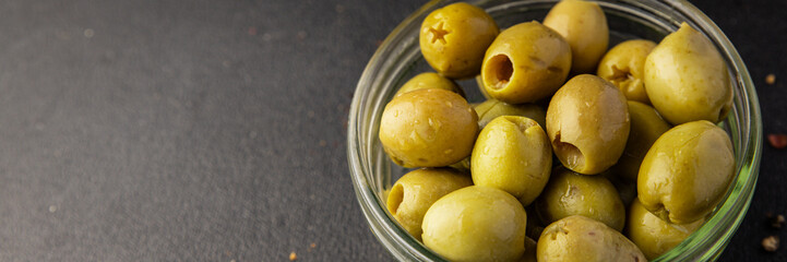 Green olives pickled seedless natural product tasty snack fresh delicious gourmet food background on the table rustic top view copy space