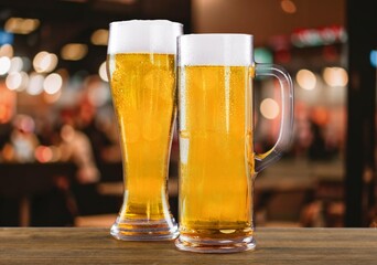 Glass of chilled tasty beer on bar tabletop