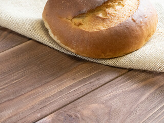 close-up of crispy bread lies on a wooden background. top view, copy space