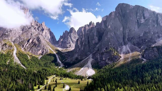 Aerial view of Langkofel mountain in Dolomites, Italy. The top of a mountain Plattkofel Sassopiatto. Dolomites mountain ridge. Seiser Alm Alpe di Siusi aerial view at Summer. Travel in Italy.