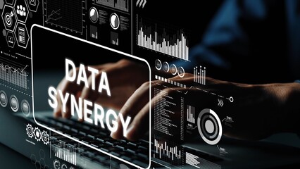 Hands Typing on Keyboard with Data Synergy Concept Overlay and Digital Graphs in Modern Workspace Environment. Asymptotic smart data analytic.